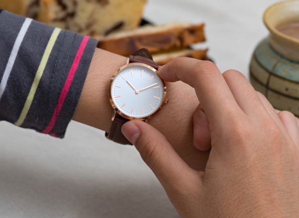 Girl’s hand with wrist watches at the coffee break