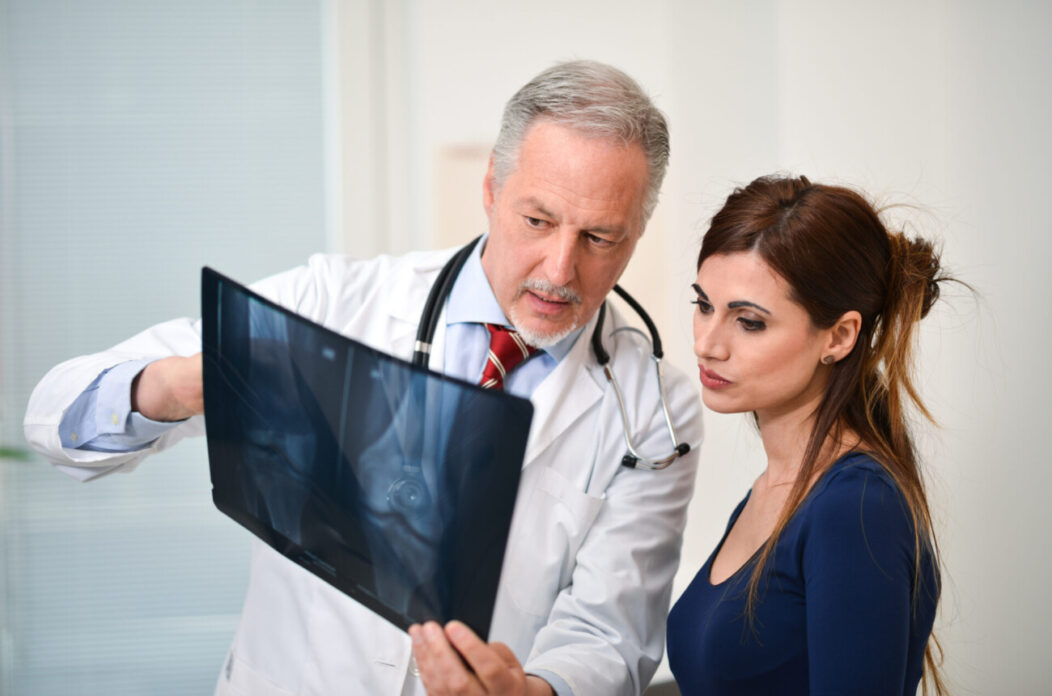 Doctor,Showing,A,Radiography,To,His,Patient Doctor,Showing,A,Radiography,To,His,Patient