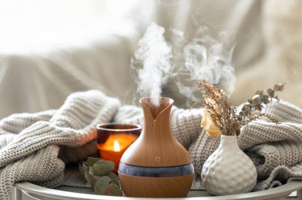 Aroma composition with a modern aroma oil diffuser and a knitted element.