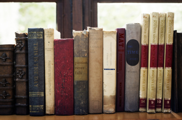 Old books arranged on the shelf