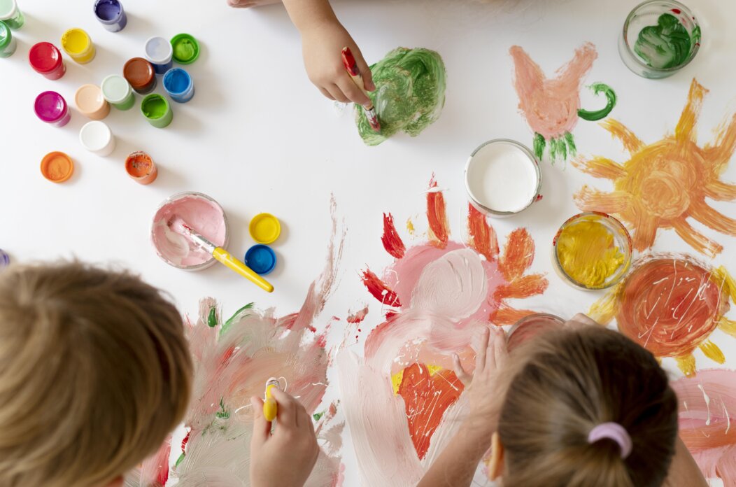 close-up-kids-painting-with-brushes-together